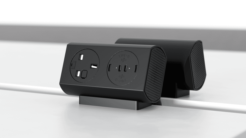 Black power strip with two round outlets and three USB-C ports on a desk stand with green indicator lights