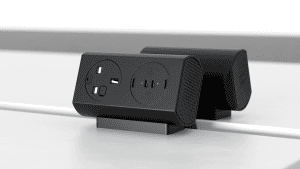 Black power strip with two round outlets and three USB-C ports on a desk stand with green indicator lights