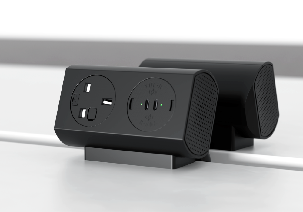 Black power strip with two round outlets and three USB-C ports on a desk stand with green indicator lights