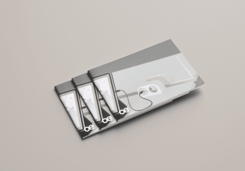 Tilted product brochure showing smartphones and accessories on a gray cover surface base.