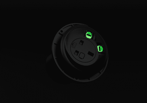 Close-up of a circular black device with two green glowing ports against a dark gradient background, highlighting its connectivity points.