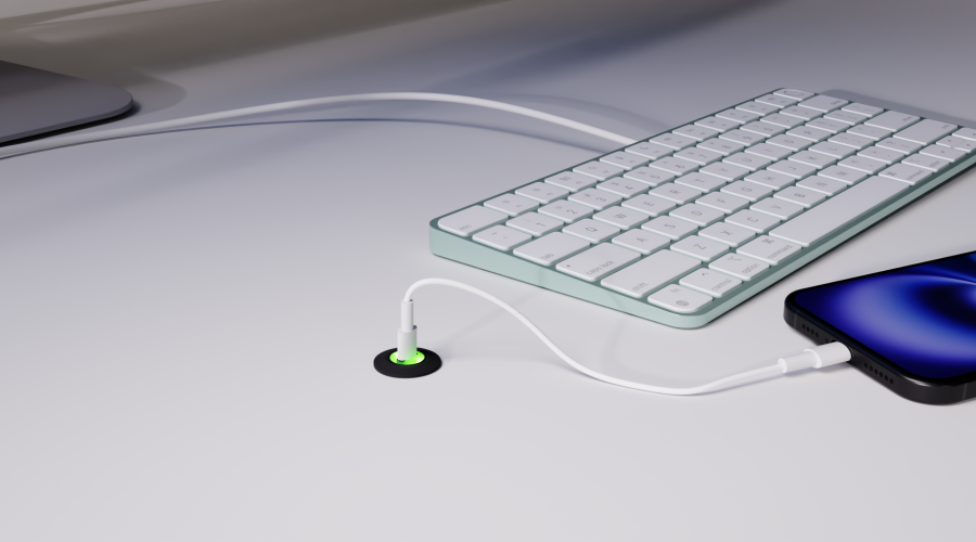 piton in a white desktop next to a keyboard, charging a phone